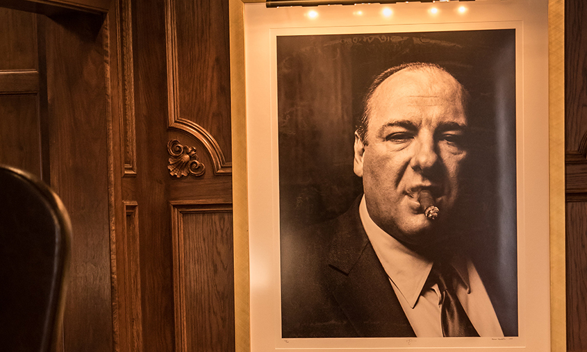 A portrait of James Gandolfini overlooks the Club Room